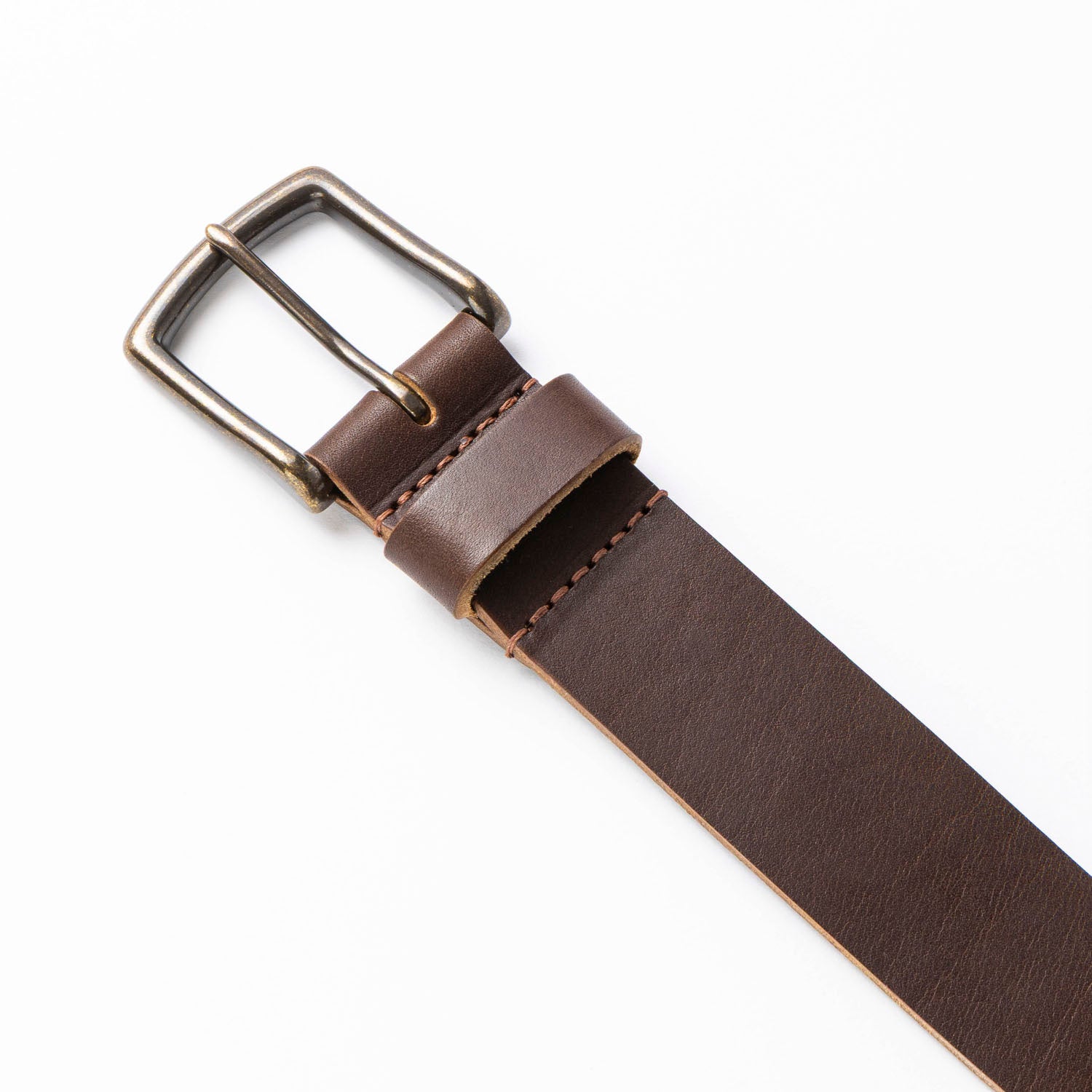Brown leather belt with a silver buckle on a white background