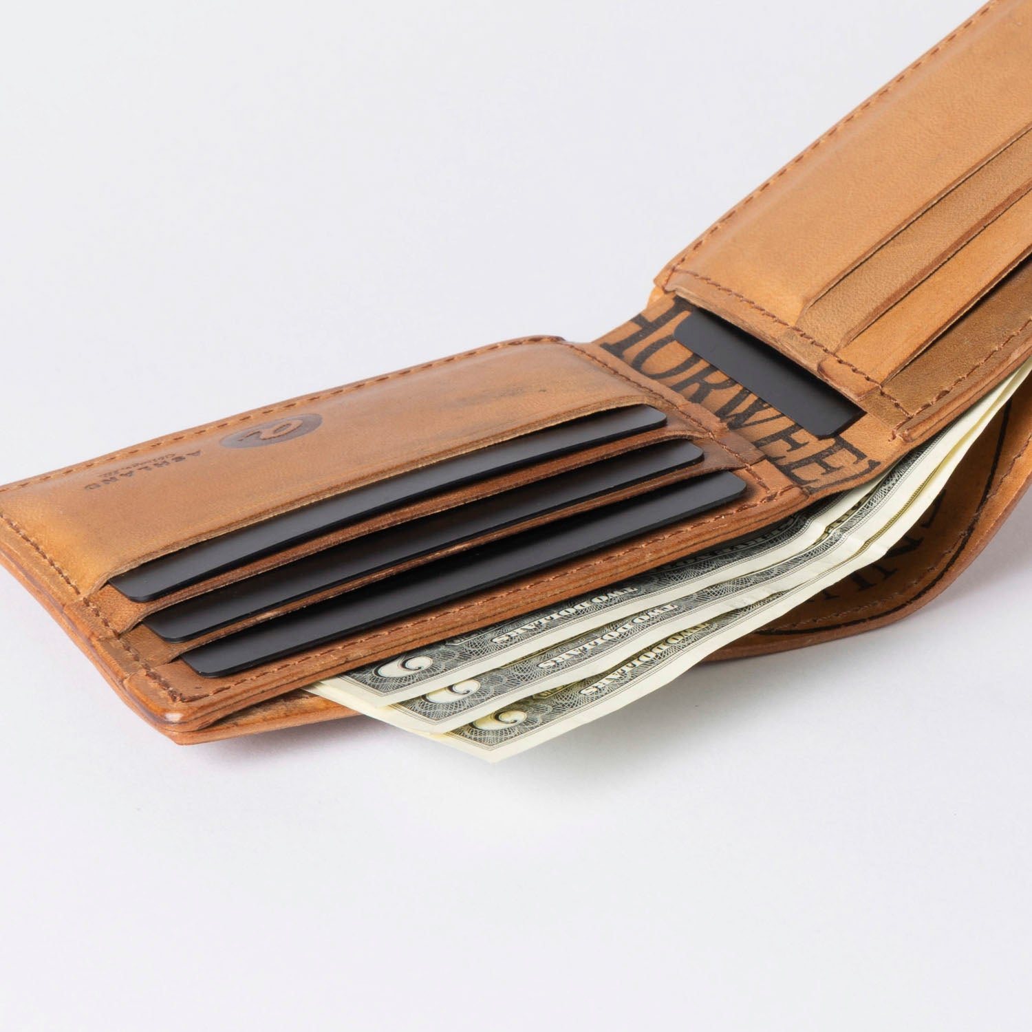 Brown leather wallet with money on a white background
