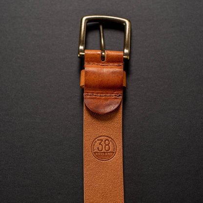 ashland leather belt laying vertically, showing back of buckle hardware with Size 38 stamp visible